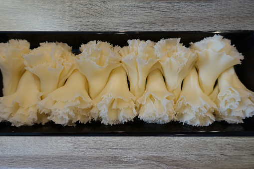 Swiss firm cheese called Tête de moine Rosettes obtained by scraping the cheese  Buffet meal