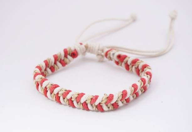 An isolated ethnic bracelet on white background. The bracelet is made off the various rope An isolated ethnic bracelet on white background. The bracelet is made off the various rope assiduity stock pictures, royalty-free photos & images