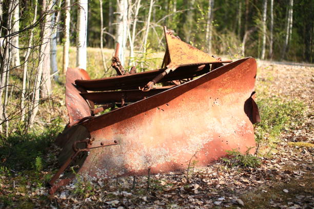 istock Historic rusty snow plow lying in the forest 1401278002