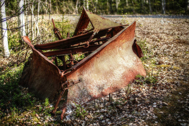 istock Historic rusty snow plow lying in the forest 1401278022
