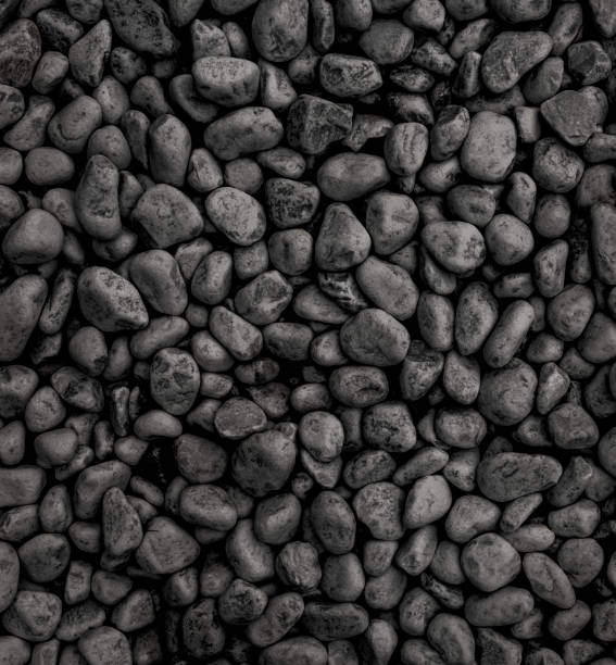 istock black stone background, many dark pebble stones - 1401280790