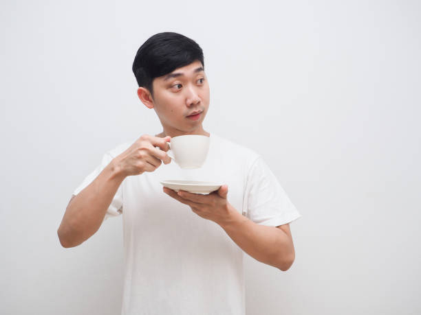 istock Asian man hold coffee cup in hand and look at right side with happy smile on white isolate background 1401281990