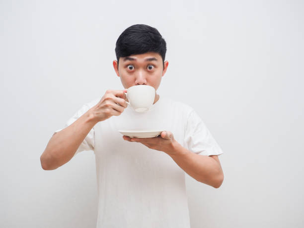 istock Man white shirt feel amazed with drink coffee in hand look at camera on white background 1401281992