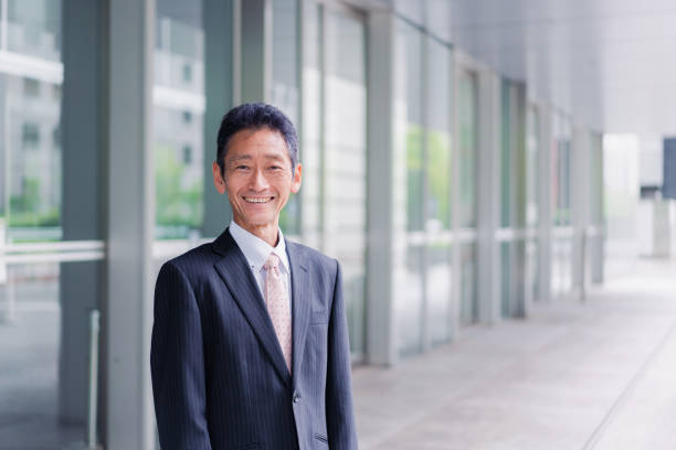 istock A businessman standing in front of his building 1401282090