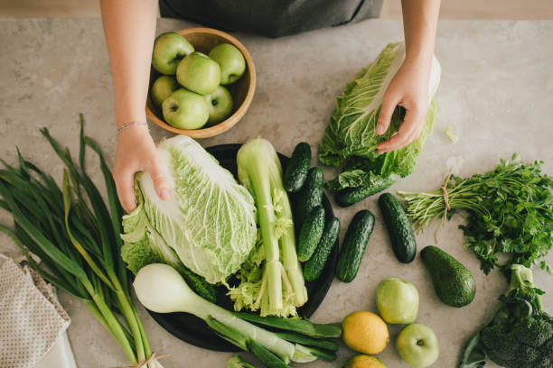 istock Still life with green fruit and vegetables on grey table in the kitchen interior. 1401283313