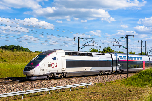 Champdeuil, France - June 1, 2022: A TGV Euroduplex inOui high speed train from french rail company SNCF is driving to Paris on the LGV Sud-Est in the countryside.