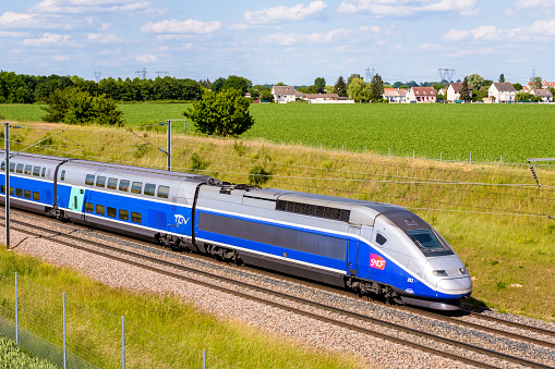 Champdeuil, France - June 1, 2022: A TGV Duplex high speed train from french rail company SNCF is driving from Paris on the LGV Sud-Est in the countryside.