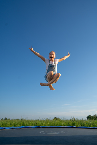 boy jumping on trampoline. the child plays on a trampoline outdoor