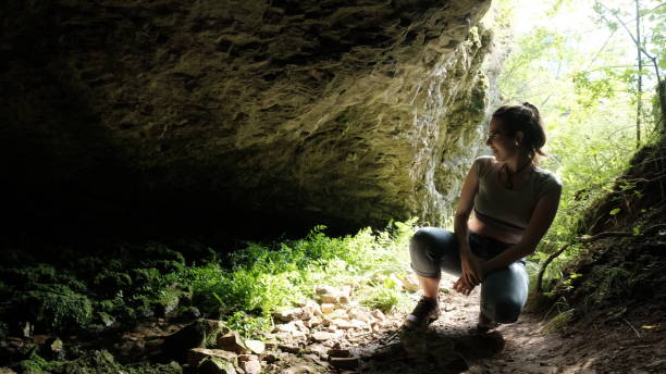 istock Young sporty female explorer in the cave 1401289206