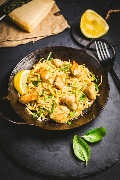 istock Lemon Chicken Pasta in cast iron pan with basil and Parmesan 1401290252