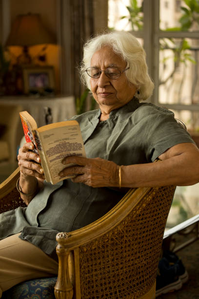 istock Woman reading a book at home 1401290585