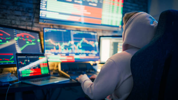 istock Young man analyzing at stock market graphs on computer screens at desk 1401290662