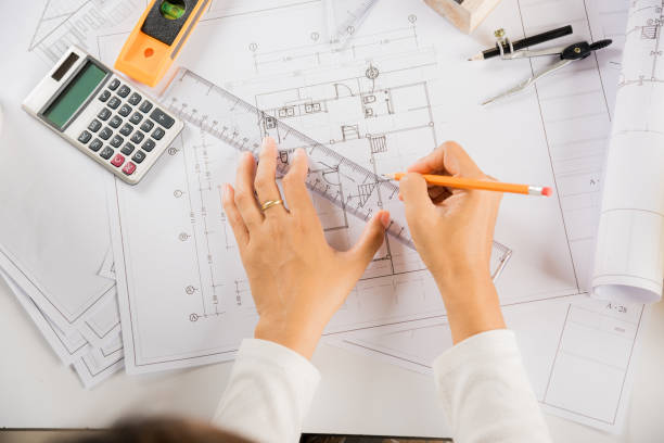 istock Architect drawing with ruler on house plan blueprint paper for repair tools on table 1401297017