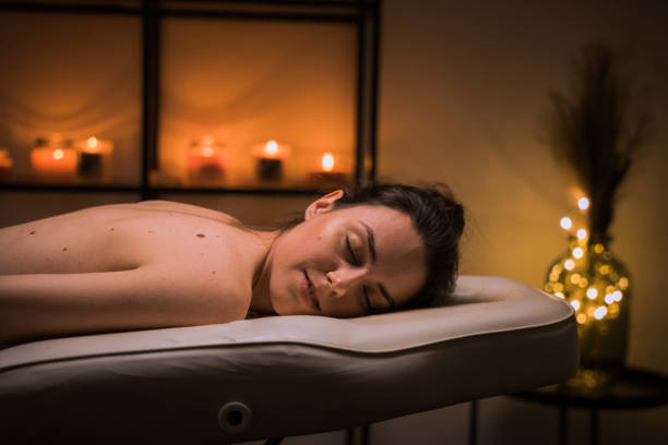 istock Young woman resting on massage table at spa salon 1401297220