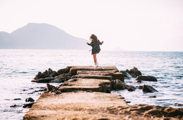 istock Woman Having Fun Like Kids on the Beach 1401297572