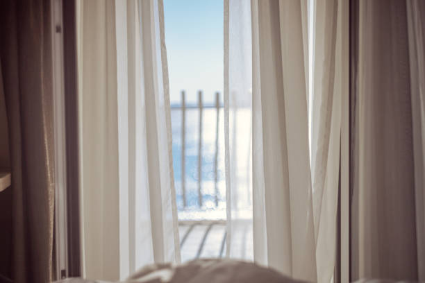 istock Curtains on open balcony window in bedroom 1401298453