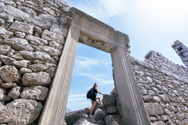 An explorer woman climbing the ancient city of Termessos, Antalya