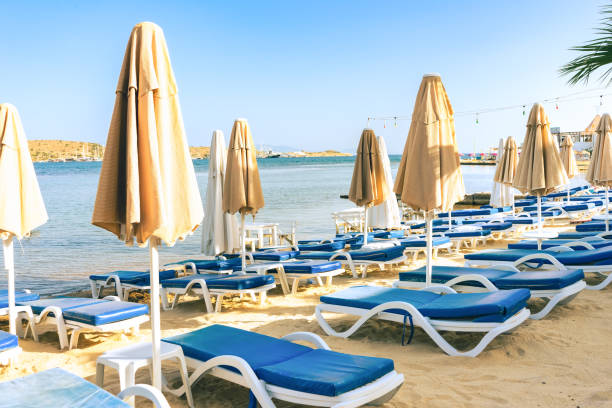 istock Empty summer beach loungers without people on seaside 1401301241