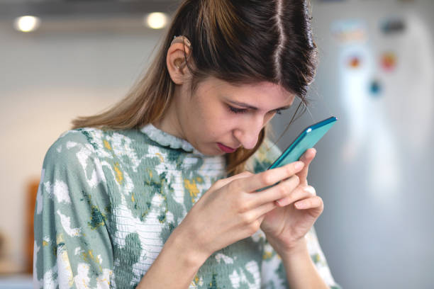 A visually impaired young woman  using smart phone.