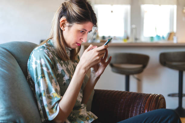 A visually impaired young woman  using smart phone.