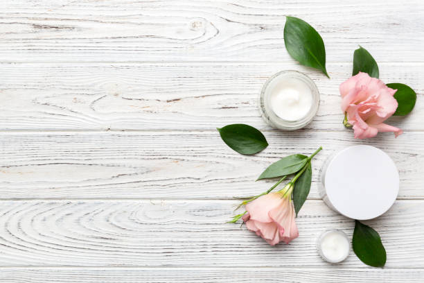 istock Composition with cosmetic products and beautiful roses on wooden background. Copy space, flat lay 1401303438