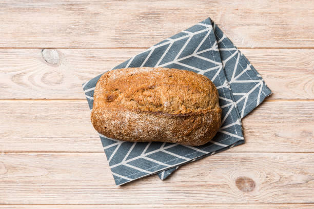 istock Fresh Homemade Whole Wheat Bread. bread on napkin on rustic background, fresh bread top view 1401304252