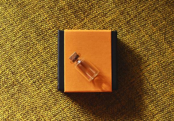 Small glass bottle and paper box.