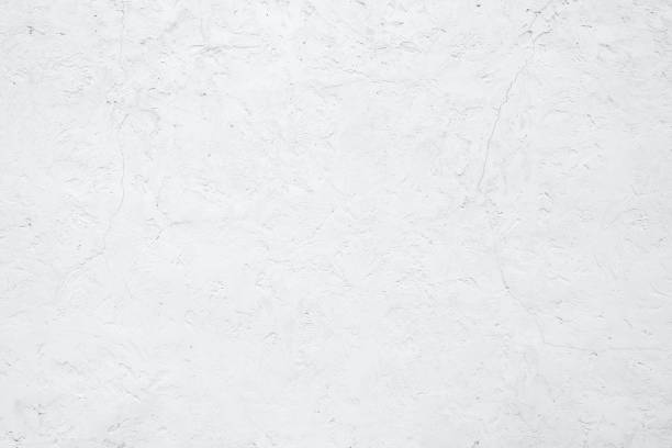 istock Empty white building wall texture background. Rough surface and cracked white cement wall. White wall texture abstract background. Concrete surface. Exterior concrete building wall. Plaster work. 1401306278