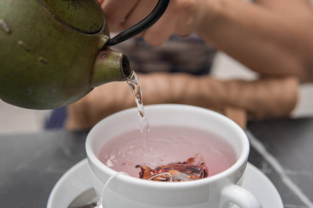 istock Woman's hands preparing tea in the cafeteria. 1401307516