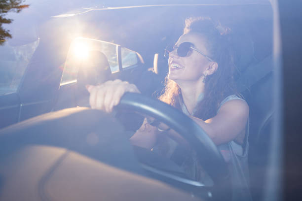 istock Woman in sunglasses driving a car 1401308055