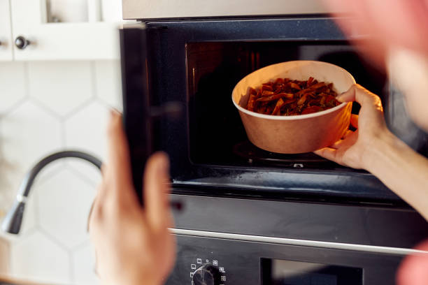 istock Guy giving foods into the microwave for warm up 1401309621