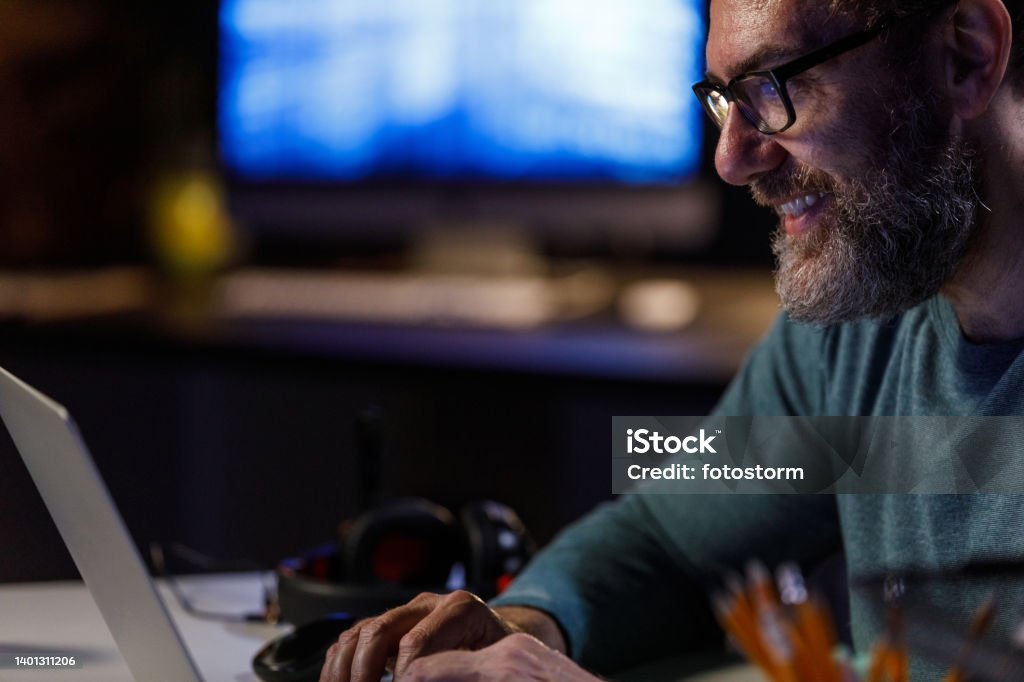 Older Computer Programmer Smiling Mature Computer Programmer Finishing Typing Out Code When ...