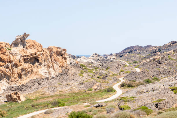 istock lonely road through cap de creus a hot summer day 1401311218