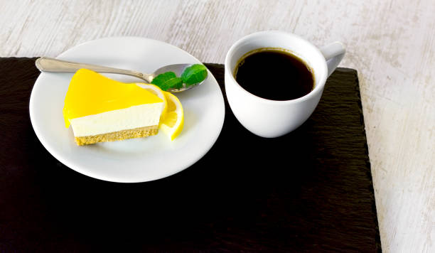 istock Cheesecake and coffee on table, delicious lemon cake 1401311580