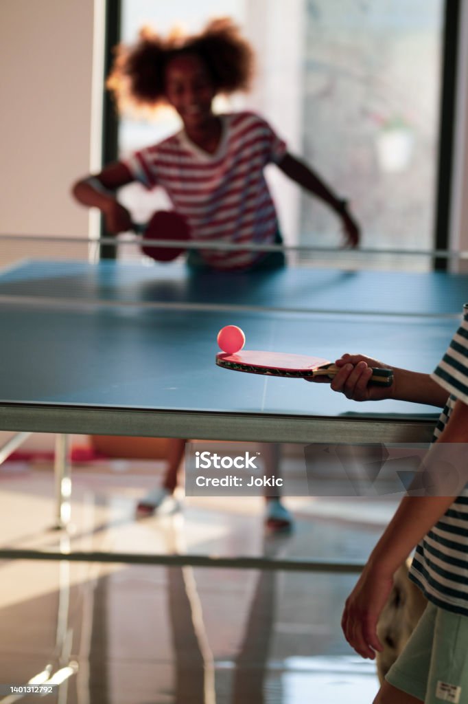 Kids playing table tennis Kids playing table tennis. Afro american etnicity Table Tennis Stock Photo