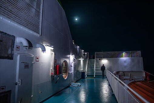 Man Walking Around a Ferry in Night Silence and tranquility During Navigation over Adriatic Sea.