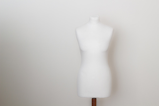 Mannequin with cloth in the white room. Dressmakers or tailors dummy or mannequin
