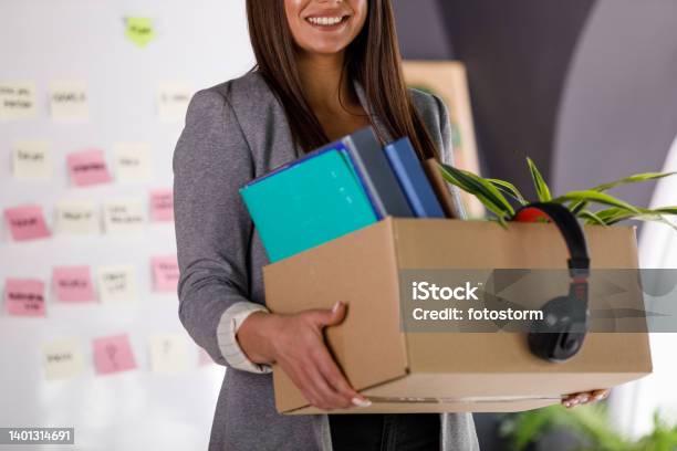 Joyful Businesswoman Smiling After Getting Hired At The Office Holding A Box With Personal Belongings Stock Photo - Download Image Now