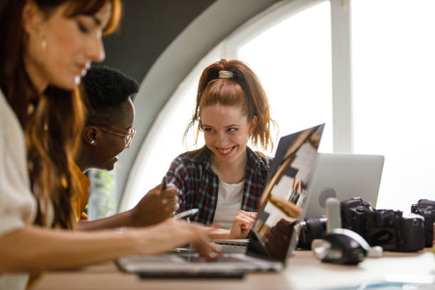 Creative businesswomen discussing project ideas while working together