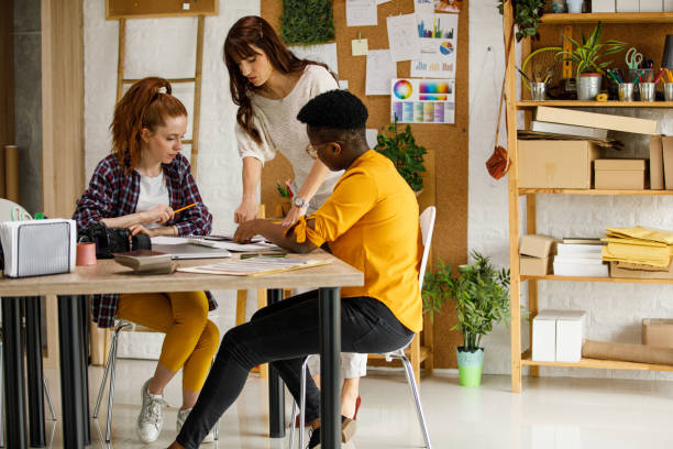 Copy space shot of three female entrepreneurs brainstorming ideas while working on a creative project