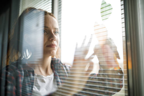 istock Female entrepreneur applying adhesive notes on a window 1401316022