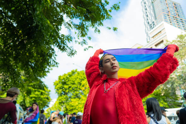 istock Confident Gay Boy Holding Rainbow Flag. 1401319423