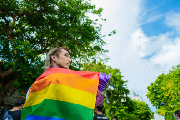 istock Confident Gay Boy Holding Rainbow Flag. 1401319427