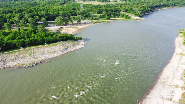istock Top view Oklahoma side of Red River with strong water current generating from Denison Dam hydroelectric station and people bank fishing for striped bass 1401319559