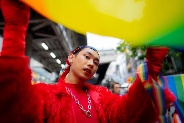 istock Confident Gay Boy Holding Rainbow Flag. 1401319569
