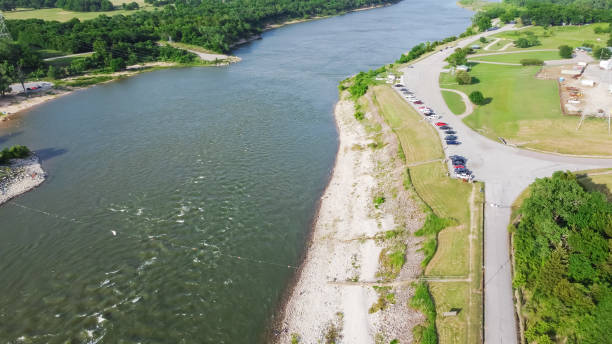 istock Aerial view Texas side of Red River with strong water current generating from Denison Dam hydroelectric station and people bank fishing for striped bass 1401319641