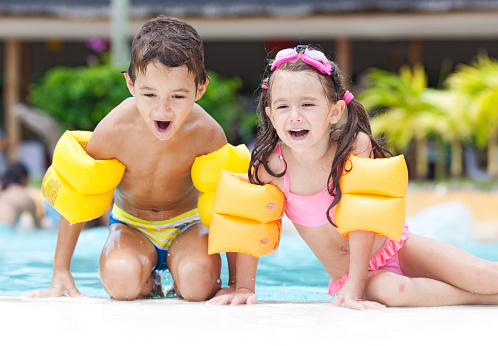 Two children having fun at the swimming pool