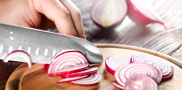 istock Man hands cutting red fresh onion with knife 1401325458