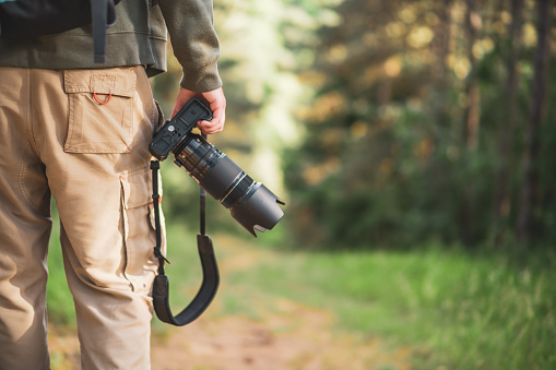 Image of man photographing  while hiking in the nature.