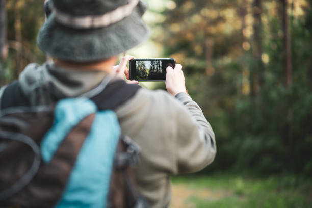 istock Man  hiking and making pictures  with phone 1401327302